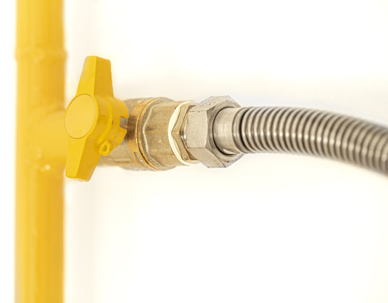 Yellow gas pipe with a valve White background